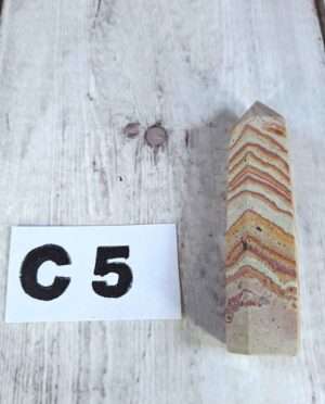 Banded sandstone point with natural sediment layers