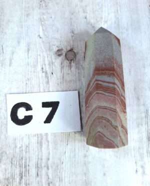 Banded Sandstone point with natural layering and earthy tones