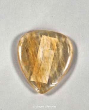 Citrine guitar pick showcasing unique mineral patterns