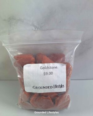 Reddish-brown goldstone tumbled stones showing metallic glitter reflections