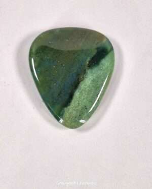 Moss Agate guitar pick showcasing dendritic landscape patterns