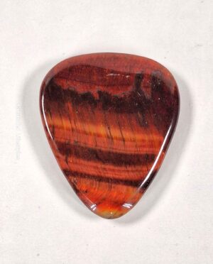 Red Tiger Eye guitar pick showcasing unique mineral patterns