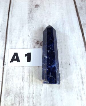 Sodalite point with deep blue and white veining