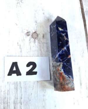 Sodalite point with deep blue color and white veining