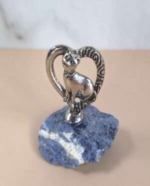 Handcrafted pewter heart with cat perched on raw sodalite crystal