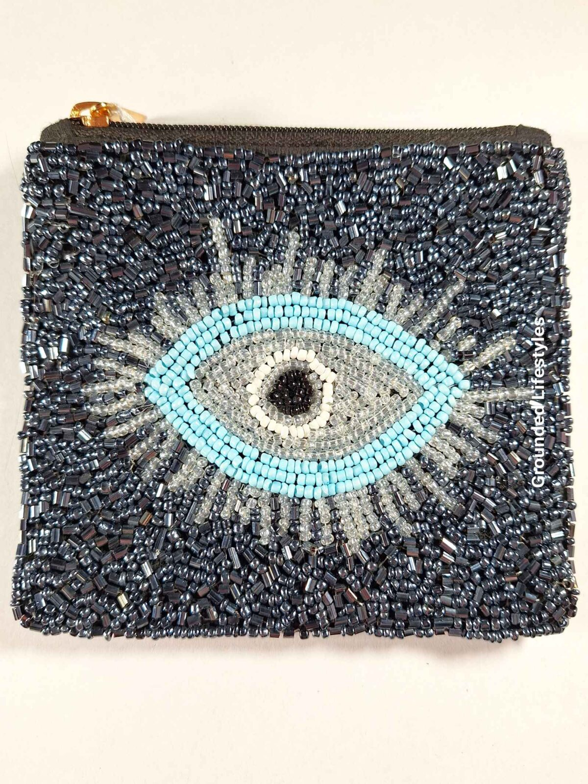 handcrafted beaded zip pouch with evil eye design