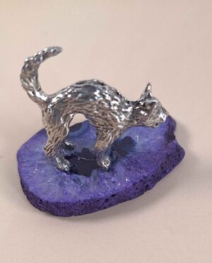 Handcrafted pewter cat perched on purple agate slice