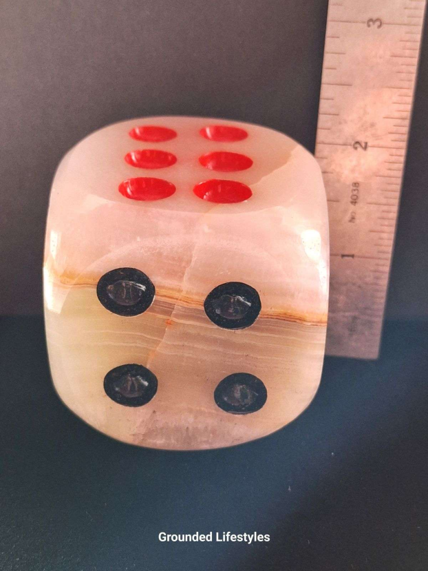 Polished gemstone dice carved from Pakistani onyx