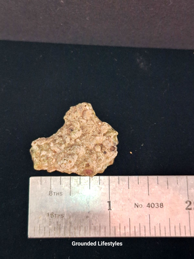 Authentic 4.0 g Trinitite fragment showing olive-green glass and vesicles.