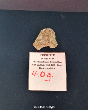 Authentic 4.0 g Trinitite fragment showing olive-green glass and vesicles.