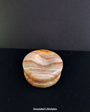 Polished onyx sphere holder 2 inches from Pakistan.