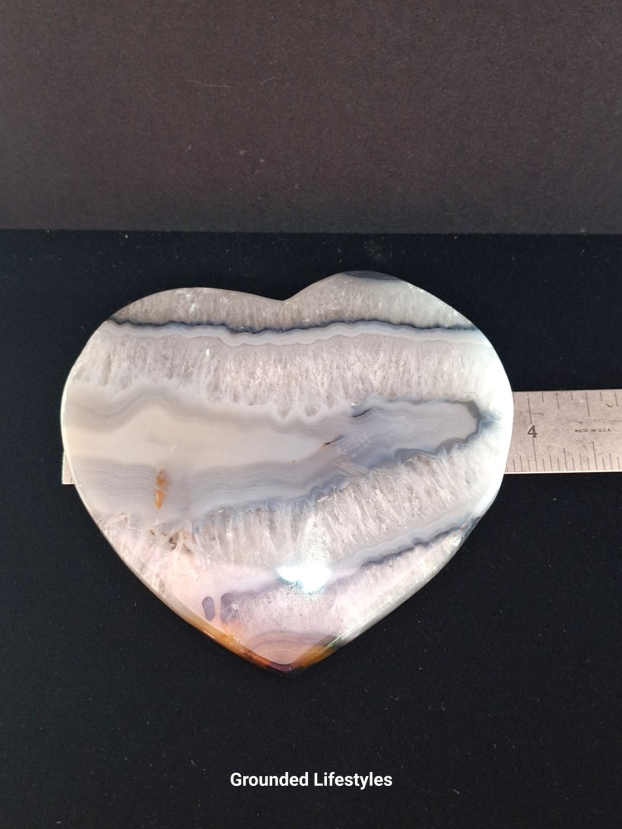 Polished Brazilian agate heart showing concentric banding and translucent tones
