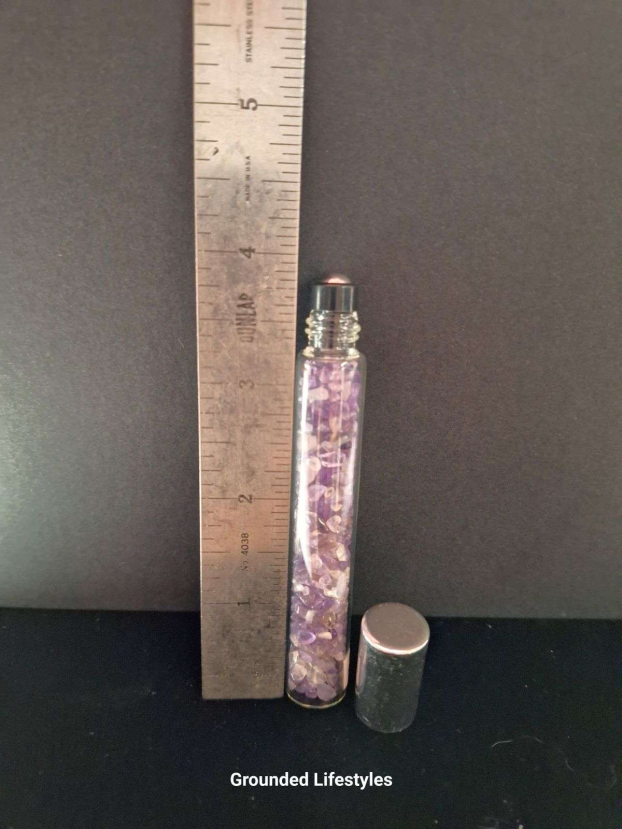 amethyst gemstone roller bottle filled with purple chips for oils or perfumes
