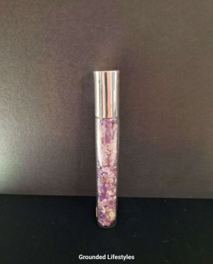 amethyst gemstone roller bottle filled with purple chips for oils or perfumes