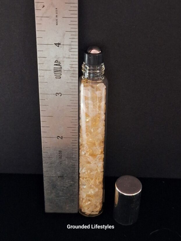 citrine gemstone roller bottle filled with golden chips for oils or perfumes