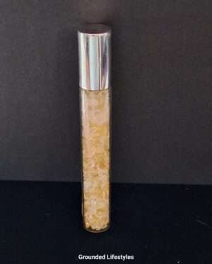 citrine gemstone roller bottle filled with golden chips for oils or perfumes