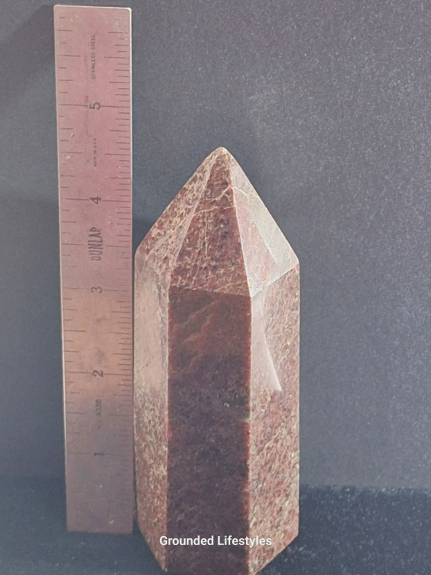 Garnet point from Madagascar 5 inches high showing red crystal inclusions.