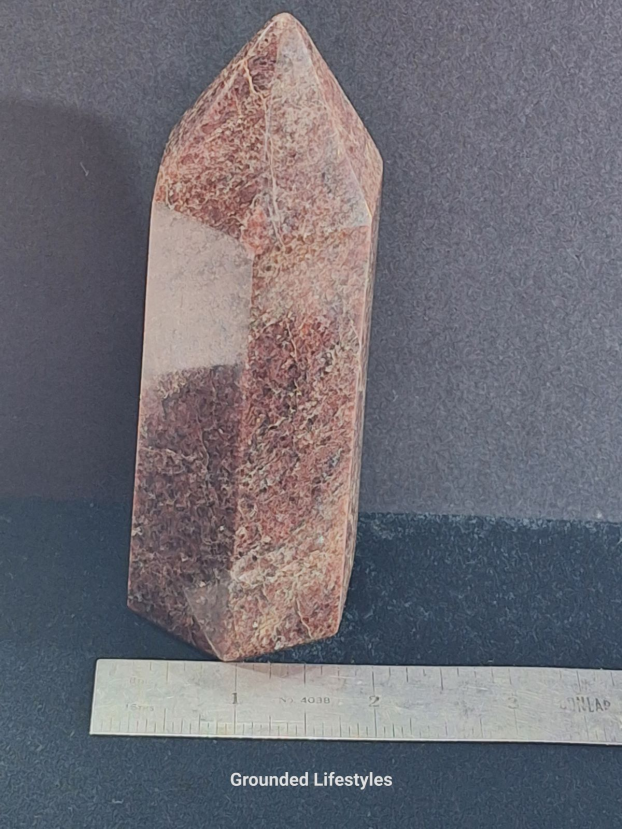 Garnet point from Madagascar 5 inches high showing red crystal inclusions.