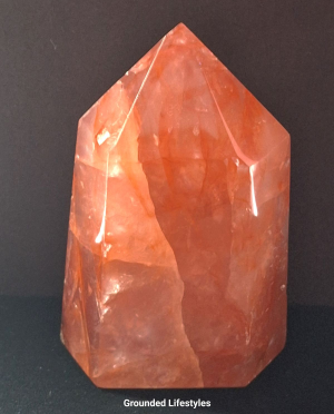 3.5 inch hematoid quartz crystal showing red and gold tones from hematite.