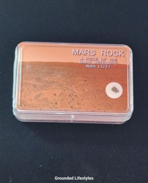 Genuine Mars meteorite fragment in labeled display box.
