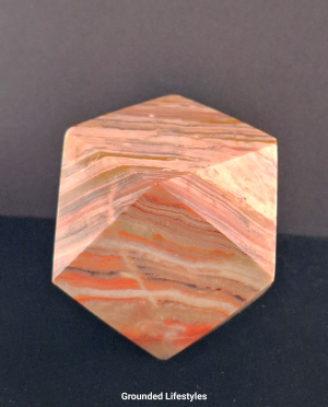 Polished onyx paperweight 2 inches from Pakistan.