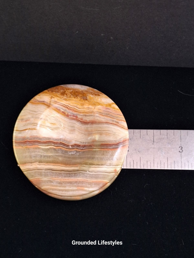 Polished onyx sphere holder 2 inches from Pakistan.