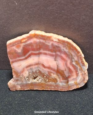 Australian Pilbara Agate polished slice displaying fine concentric bands.