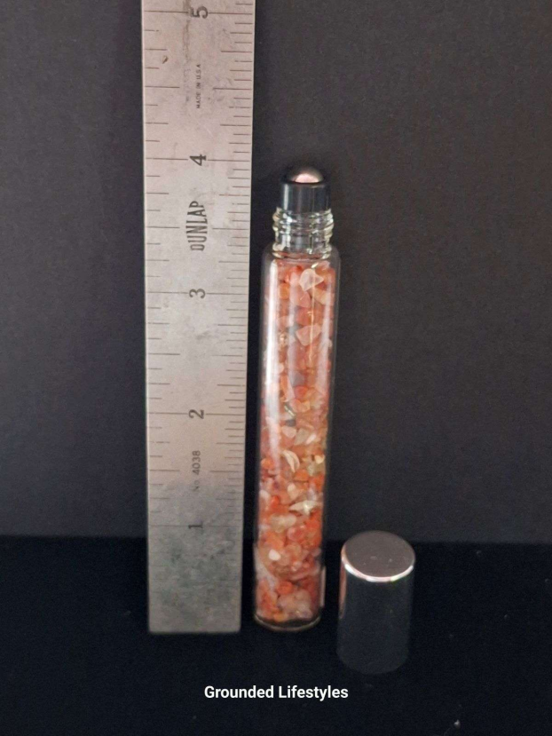 red jasper gemstone roller bottle filled with earthy red chips for oils or perfumes