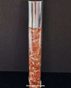 red jasper gemstone roller bottle filled with earthy red chips for oils or perfumes