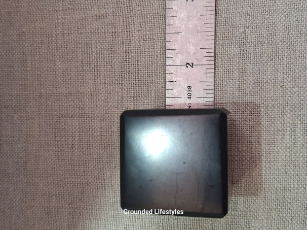 Shungite cube from Russia measuring 1.25 inches with smooth black luster.