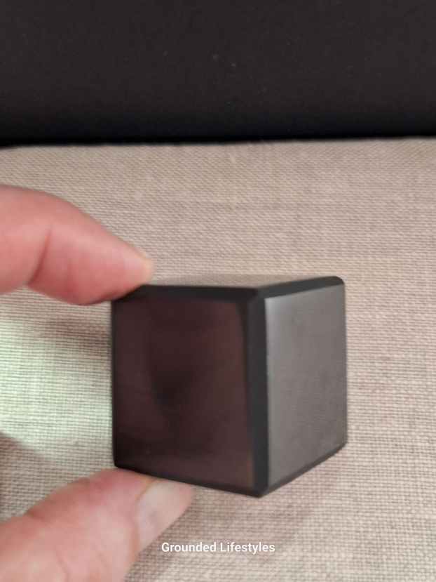 Shungite cube from Russia measuring 1.25 inches with smooth black luster.