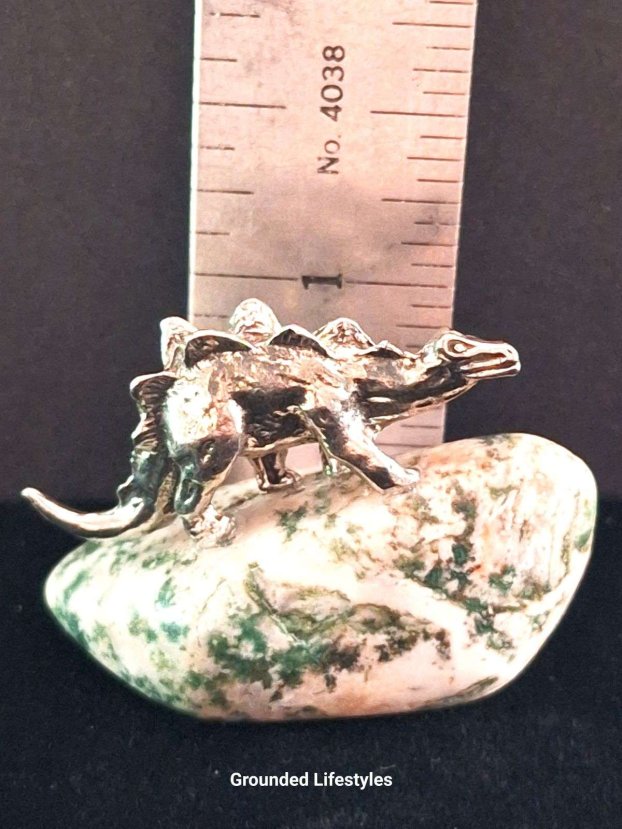 Hand-cast pewter stegosaurus figurine on polished tree agate base
