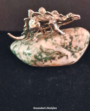 Hand-cast pewter stegosaurus figurine on polished tree agate base