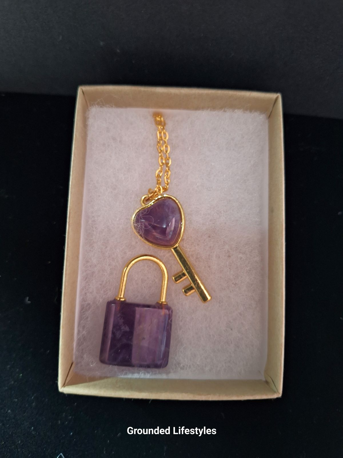 polished amethyst lock and key crystal carvings in box