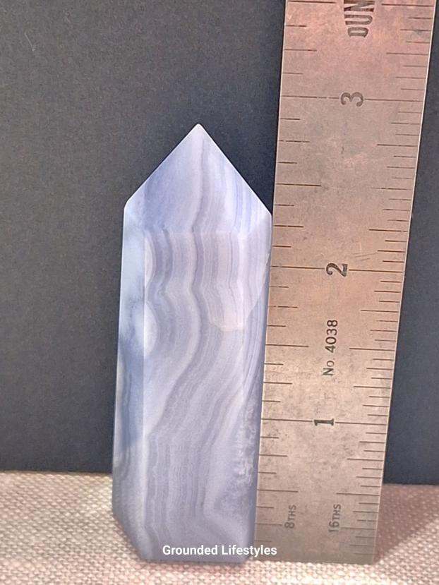 polished blue lace agate point 3 inch showing pale blue stripes