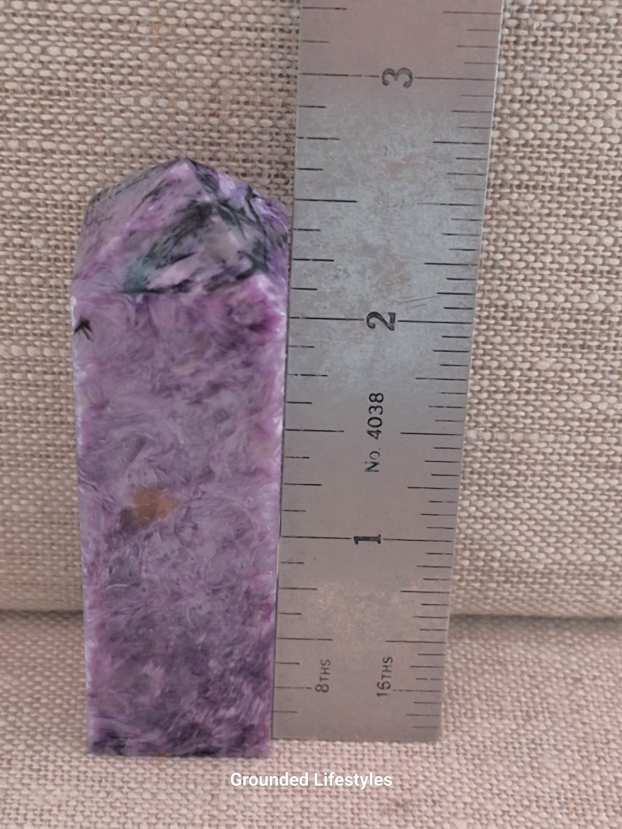 3 inch charoite point with swirling purple and black patterns