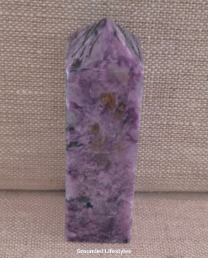 3 inch charoite point with swirling purple and black patterns
