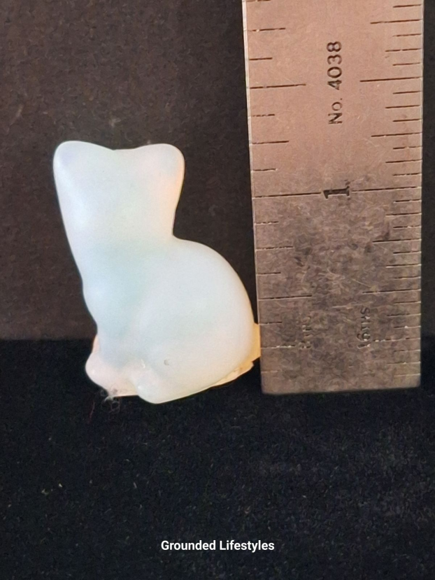 polished opalite cat miniature with glowing white and blue tones