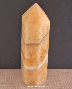 orange calcite point 3.25 inch showing layered banding