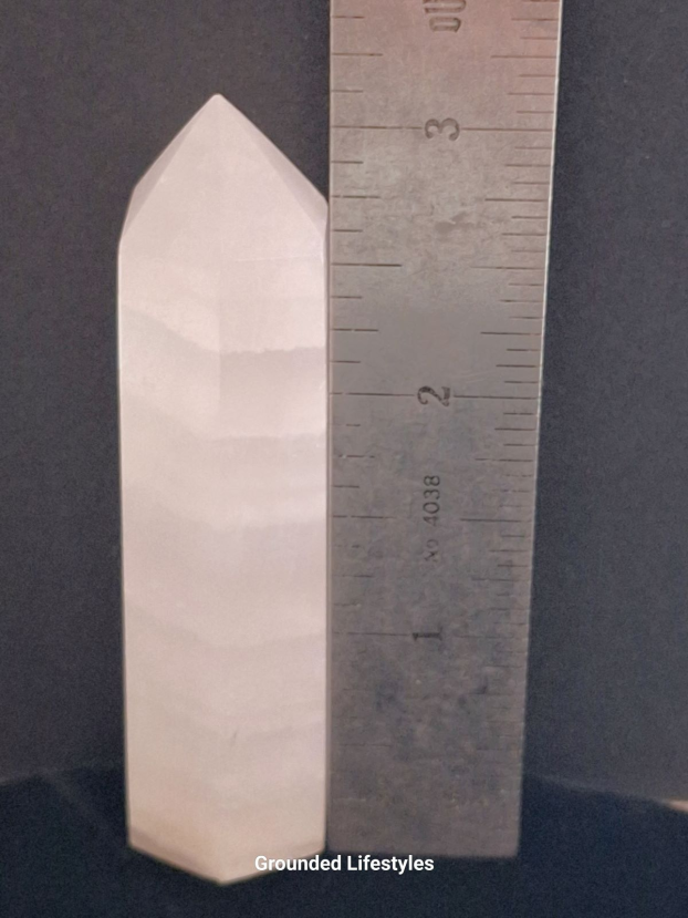 polished pink calcite point 3.25 inch showing banded structure