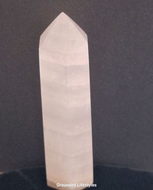 polished pink calcite point 3.25 inch showing banded structure
