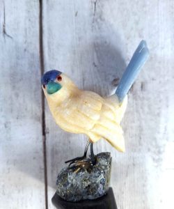 Hand-carved calcite bird figurine with natural translucence and polished finish