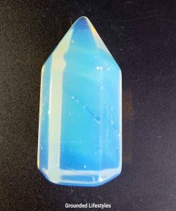 1-inch Opalite crystal tower with translucent white hue and iridescent sheen